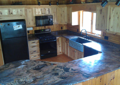 Rustic hickory cabinets, granite sink, Brazilian fusion chiseled edge countertop